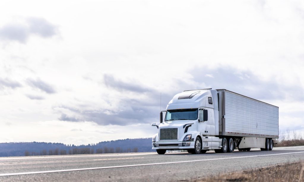 White Truck Driving Down on a Highway