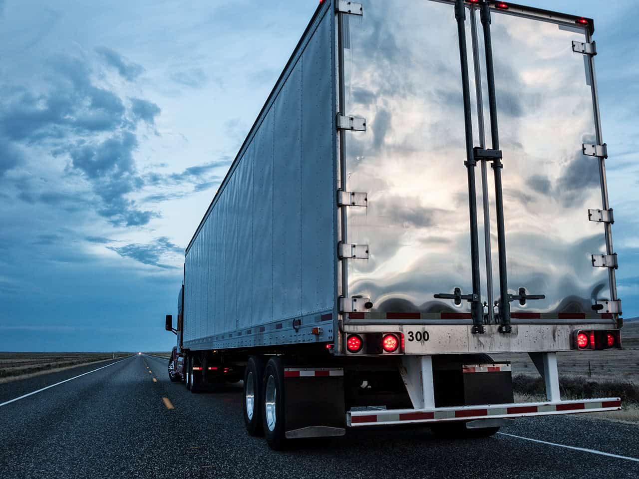 commercial truck driving down a highway