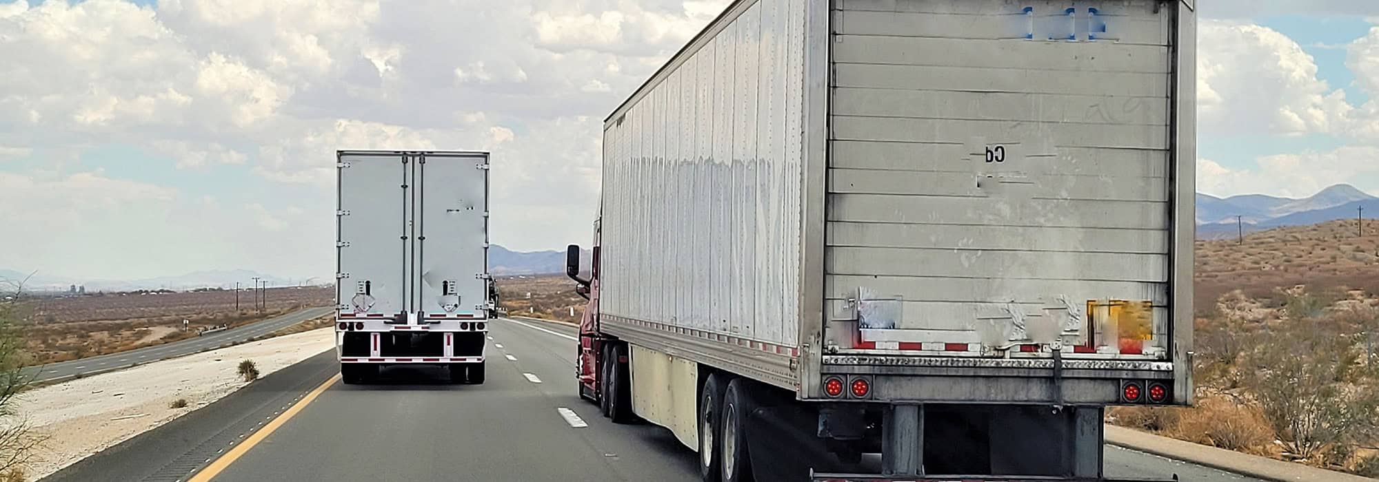 trucks blocking both lanes on a highway