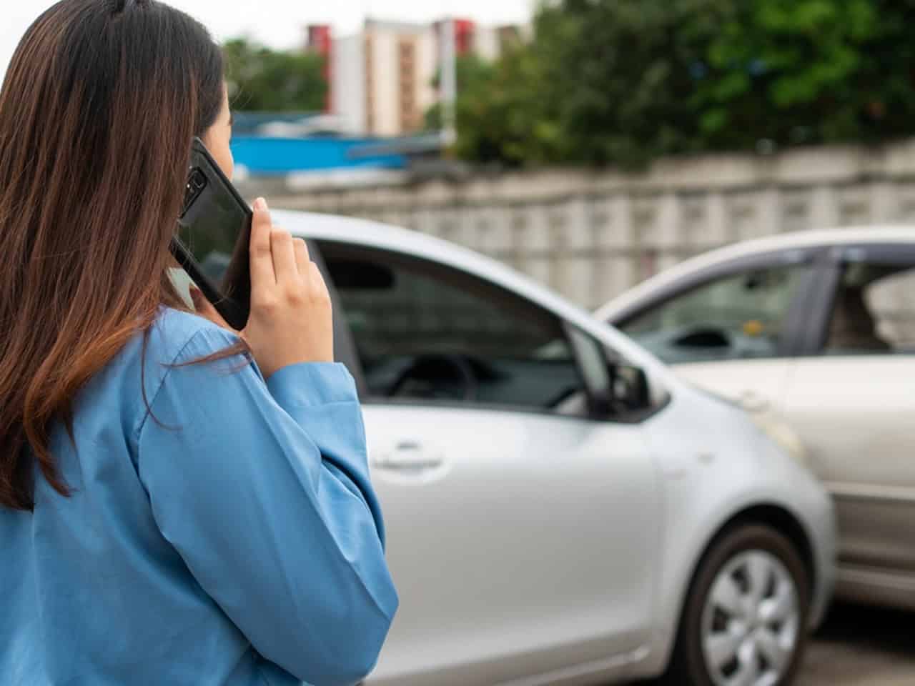 Woman on the phone with police after an accident