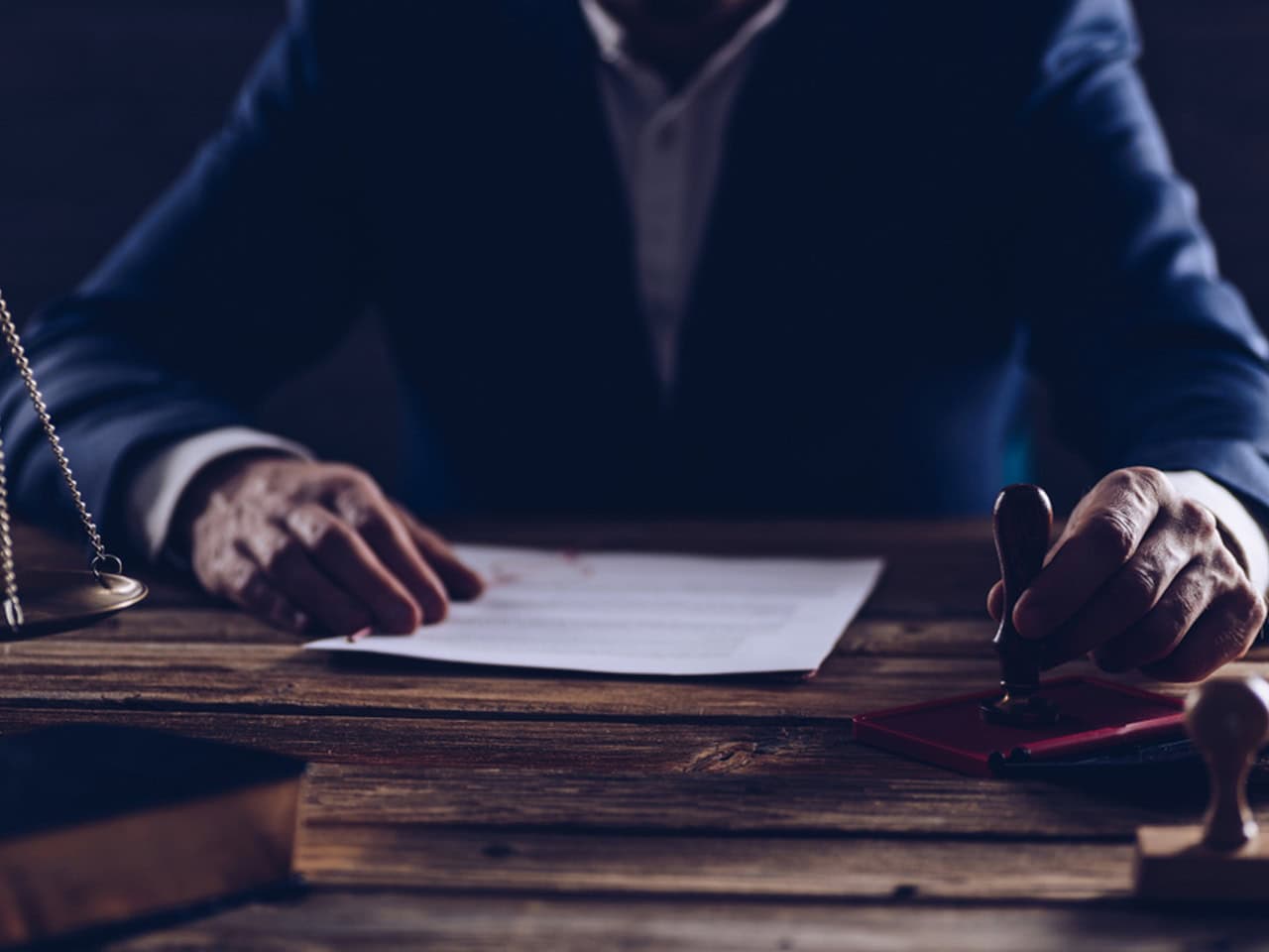Attorney at table with a a document stamp