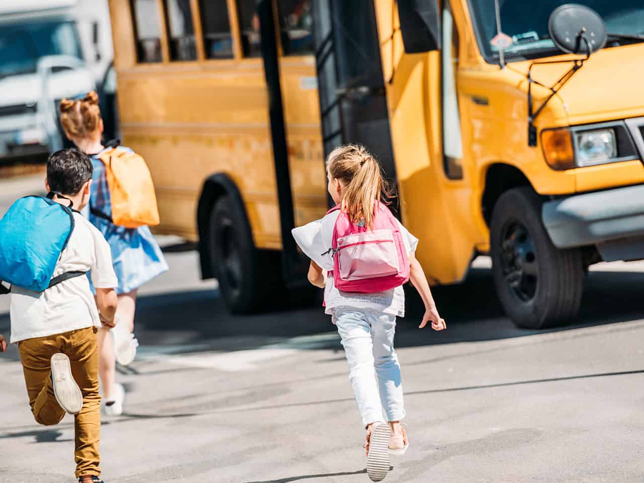 Kids getting onto a school bus