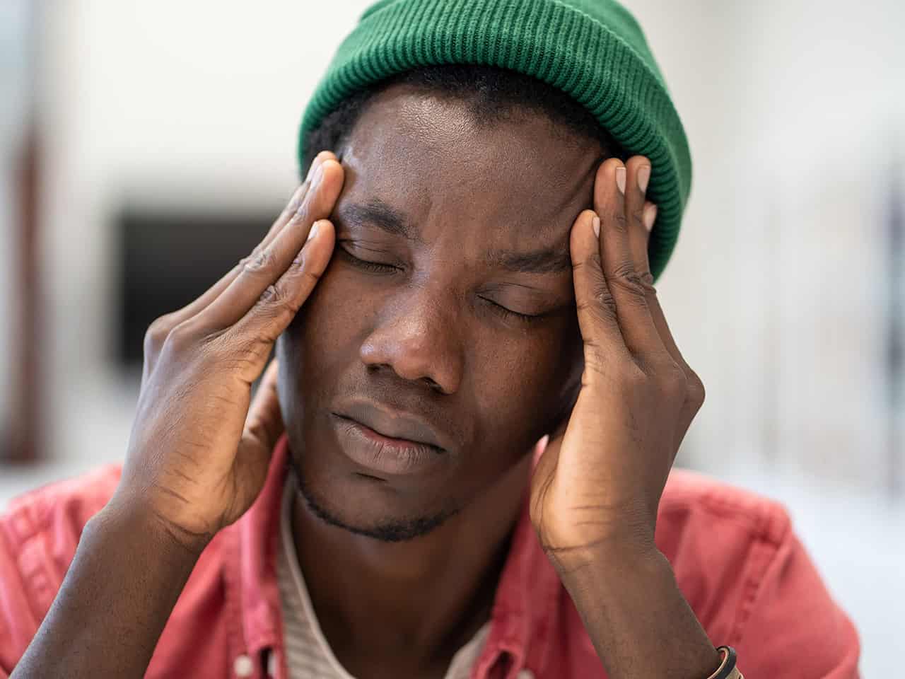 Man holding his head in pain