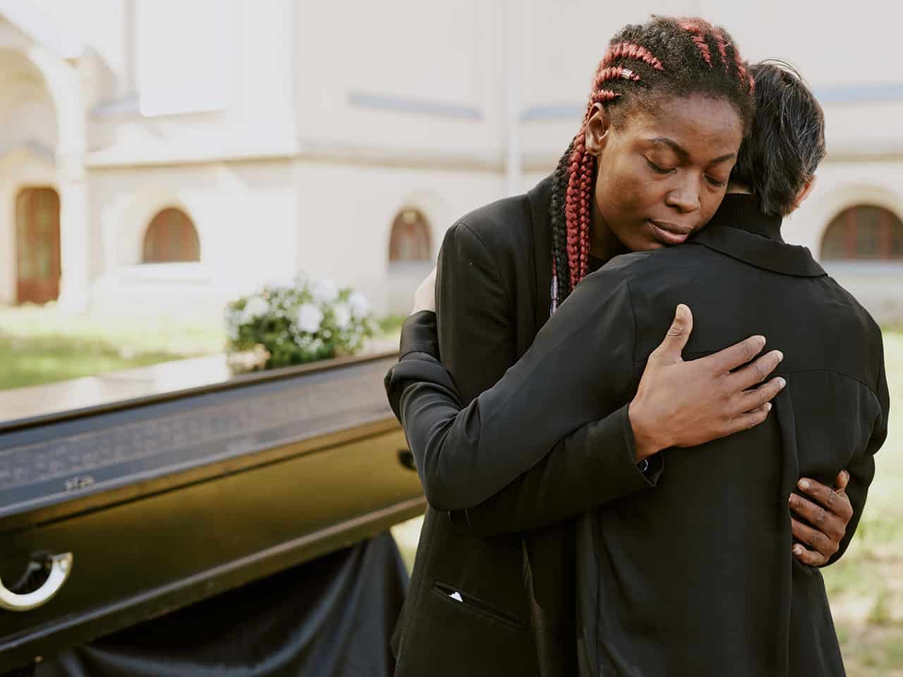 Two people embracing after the death of a loved one