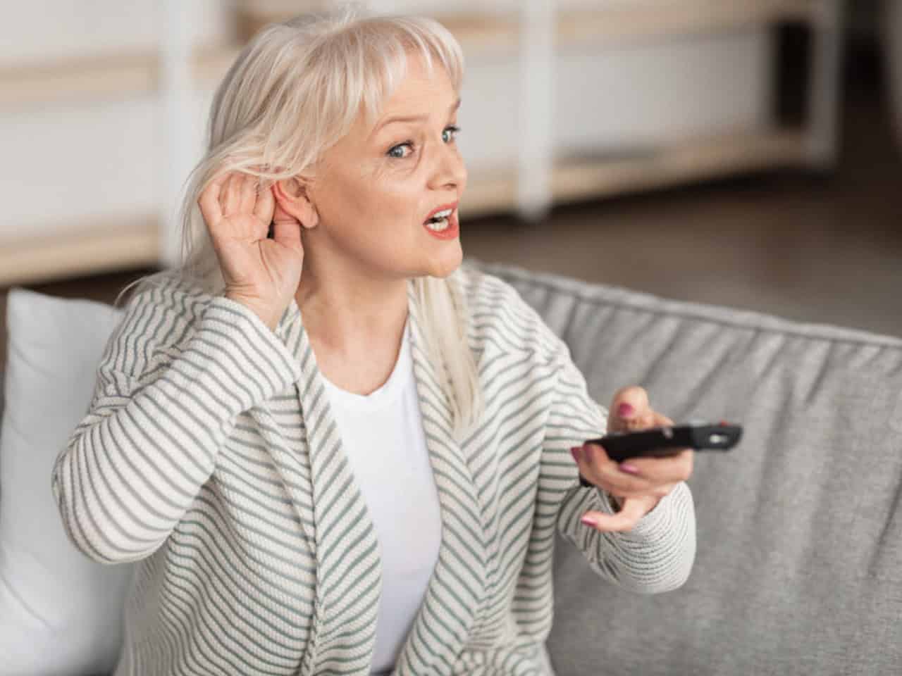 Woman cupping her ear