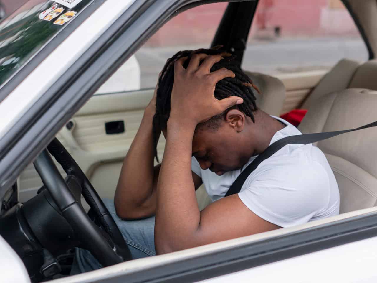 Young man in car after an accident