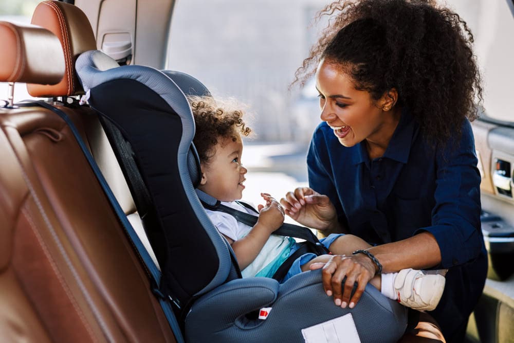 Mother comforting child in the child seat