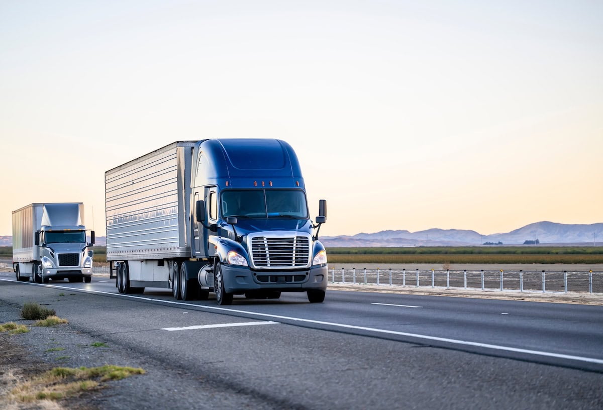 Trucks Driving Down a Highway