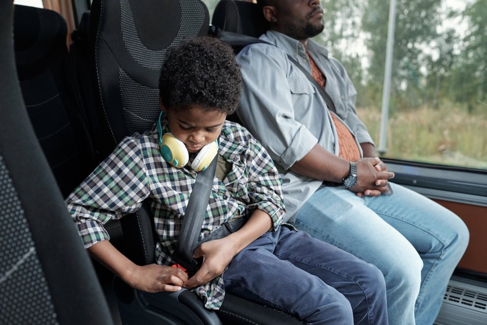 Photo of a Child Fixing Seat Belt 