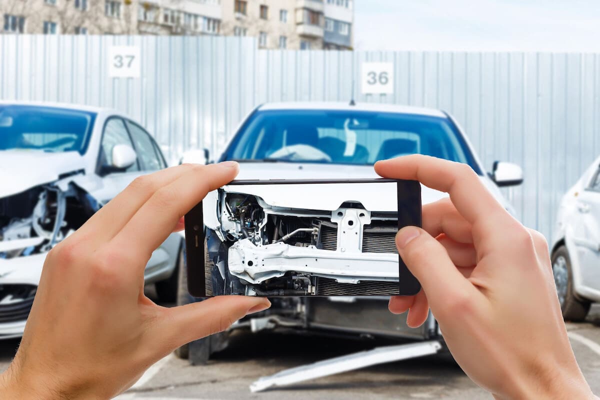 Person Taking Picture of Car After Head-On Collision