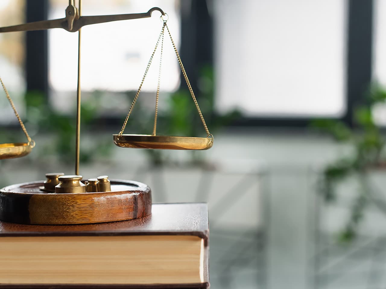 Scales of justice and legal book on desk